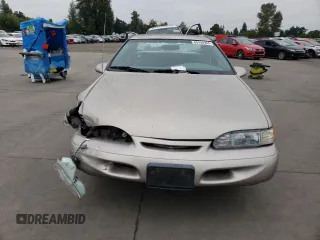 1995 Ford Thunderbird LX with VIN 1FALP62W45H169199, listed as a Copart auction lot 65458964 with 111,726 mi miles and Salvage Title. Bid and sale history available at DreamBid. Image 5.