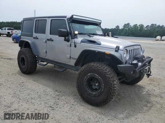 2013 Jeep Wrangler Unlimited Rubicon with VIN 1C4BJWFG5DL661282, listed as a Copart auction lot 57471035 with 128,400 mi miles and Salvage title. Bid and sale history available at DreamBid. Image 4.