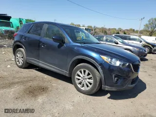 2014 Mazda CX-5 Touring with VIN JM3KE4CY4E0407868, listed as a Copart auction lot 52564315 with 137,989 mi miles and Salvage Title. Bid and sale history available at carsss.com. Image 4.
