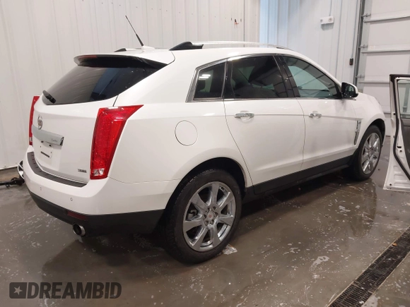 2012 Cadillac SRX Premium Collection z VIN 3GYFNFE38CS591123, wystawiony jako IAAI lot #41827636 z przebiegiem 143 867 mil mil oraz . Historia ofert i sprzedaży dostępna na DreamBid. Obrazek 4.
