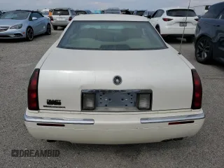 1999 Cadillac Eldorado z VIN 1G6EL12Y7XU615169, wystawiony jako Copart lot #76459744 z przebiegiem Nie podano mil oraz Szkoda całkowita • Salvage title. Historia ofert i sprzedaży dostępna na DreamBid. Obrazek 6.