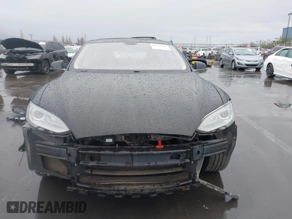 2013 Tesla Model S with VIN 5YJSA1CN0DFP20053, listed as a IAAI auction lot 41470660 with 61,568 mi miles and . Bid and sale history available at DreamBid. Image 13.