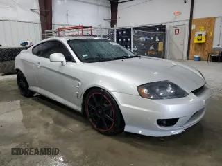 2006 Hyundai Tiburon GT z VIN KMHHN65F96U203924, wystawiony jako Copart lot #43624185 z przebiegiem 120 403 mil mil oraz Szkoda całkowita • Salvage title. Historia ofert i sprzedaży dostępna na DreamBid. Obrazek 4.