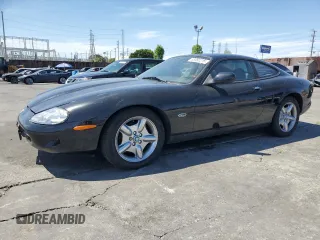 1997 Jaguar XK with VIN SAJGX5740VC014035, listed as a Copart auction lot 53066215 with 140,692 mi miles and Salvage Title. Bid and sale history available at DreamBid. Image 1.