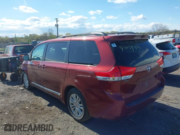 2014 Toyota Sienna XLE with VIN 5TDYK3DC8ES457940, listed as a IAAI auction lot 42039472 with 99,769 mi miles and . Bid and sale history available at DreamBid. Image 3.
