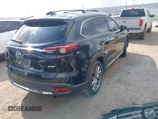 2017 Mazda CX-9 Grand Touring with VIN JM3TCADY5H0129798, listed as a IAAI auction lot 42079754 with 128,403 mi miles and . Bid and sale history available at DreamBid. Image 4.