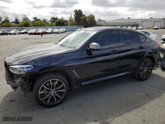 2020 BMW X4 M40i with VIN 5UX2V5C03LLE69705, listed as a Copart auction lot 71677404 with NaN miles and Salvage Title. Bid and sale history available at carsss.com. Image 1.