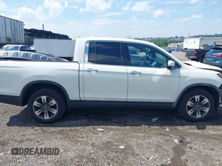 2019 Honda Ridgeline RTL-E with VIN 5FPYK3F71KB017906, listed as a IAAI auction lot 42670476 with 58,288 mi miles and . Bid and sale history available at DreamBid. Image 14.