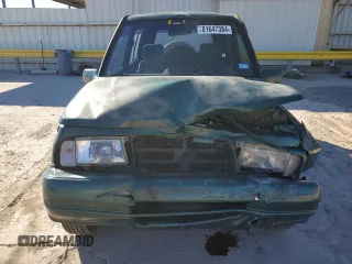 1996 Geo Tracker z VIN 2CNBE1363T6921541, wystawiony jako Copart lot #81647384 z przebiegiem 61 806 mil mil oraz Szkody całkowita. Historia ofert i sprzedaży dostępna na DreamBid. Obrazek 5.