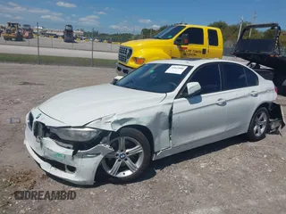 2014 BMW 3 Series 320i with VIN WBA3B1C51EK131063, listed as a IAAI auction lot 42043086 with 92,306 mi miles. Bid and sale history available at carsss.com. Image 2.