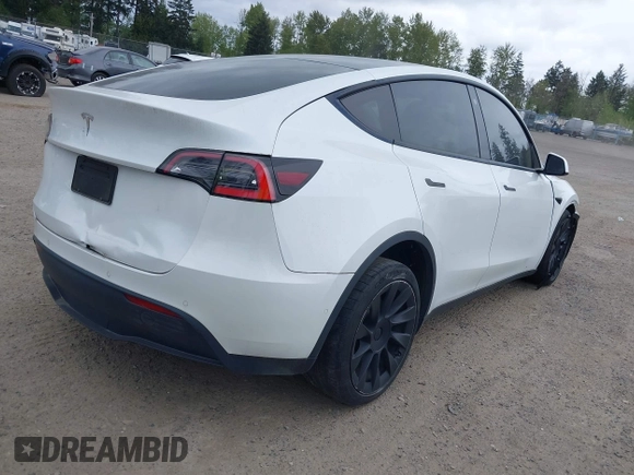 2021 Tesla Model Y Standard Range with VIN 5YJYGDED9MF121828, listed as a IAAI auction lot 42119518 with 34,454 mi miles and . Bid and sale history available at carsss.com. Image 4.