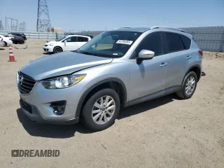 2016 Mazda CX-5 Touring z VIN JM3KE2CY3G0658985, wystawiony jako Copart lot #54704265 z przebiegiem Nie podano mil oraz Szkoda całkowita • Salvage title. Historia ofert i sprzedaży dostępna na DreamBid. Obrazek 1.