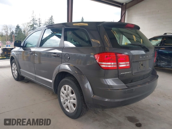 2015 Dodge Journey SE z VIN 3C4PDCAB1FT617794, wystawiony jako IAAI lot #41922371 z przebiegiem 130 558 mil mil oraz . Historia ofert i sprzedaży dostępna na DreamBid. Obrazek 3.