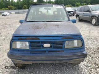 1993 Geo Tracker z VIN 2CNBJ18UXP6921660, wystawiony jako Copart lot #58027275 z przebiegiem 64 349 mil mil oraz Tytuł czysty. Historia ofert i sprzedaży dostępna na DreamBid. Obrazek 5.