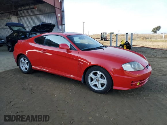 2003 Hyundai Tiburon GT z VIN KMHHN65F63U060104, wystawiony jako Copart lot #84560184 z przebiegiem 160 120 mil mil oraz Czysty tytuł • Clean title. Historia ofert i sprzedaży dostępna na DreamBid. Obrazek 4.