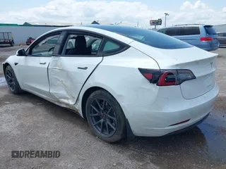 2023 Tesla Model 3 with VIN 5YJ3E1EA5PF407054, listed as a IAAI auction lot 42313770 with 57,621 mi miles and . Bid and sale history available at DreamBid. Image 3.