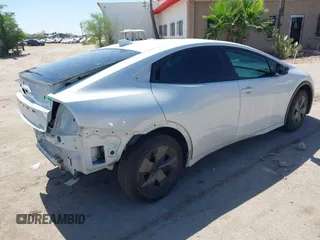 2024 Toyota Prius LE with VIN JTDACAAU5R3046244, listed as a IAAI auction lot 42464523 with 13,590 mi miles and . Bid and sale history available at DreamBid. Image 4.
