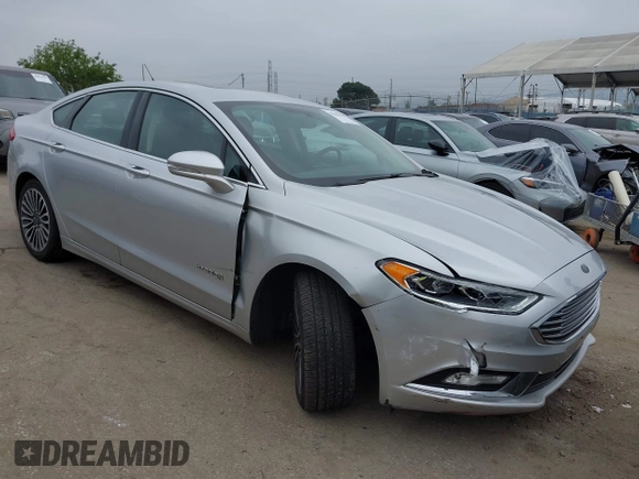 2017 Ford Fusion Hybrid Titanium z VIN 3FA6P0RU7HR300311, wystawiony jako IAAI lot #42045664 z przebiegiem 136 231 mil mil oraz . Historia ofert i sprzedaży dostępna na DreamBid. Obrazek 1.