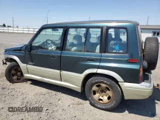 1998 Suzuki Sidekick z VIN JS3TD21V9W4103914, wystawiony jako Copart lot #62112514 z przebiegiem 394 872 mil mil oraz Szkody całkowita. Historia ofert i sprzedaży dostępna na DreamBid. Obrazek 2.
