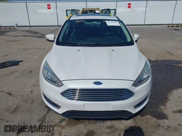 2016 Ford Focus Titanium z VIN 1FADP3J23GL358772, wystawiony jako IAAI lot #42103694 z przebiegiem 85 290 mil mil oraz . Historia ofert i sprzedaży dostępna na DreamBid. Obrazek 12.