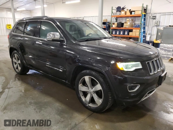 2015 Jeep Grand Cherokee Overland with VIN 1C4RJFCG7FC911899, listed as a Copart auction lot 54123925 with 243,031 mi miles and Salvage Title. Bid and sale history available at carsss.com. Image 4.