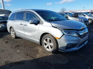 2018 Honda Odyssey EX-L z VIN 5FNRL6H7XJB045579, wystawiony jako IAAI lot #41592720 z przebiegiem 77 493 mil mil oraz . Historia ofert i sprzedaży dostępna na DreamBid. Obrazek 1.