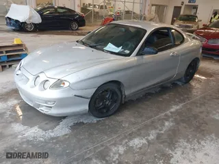2001 Hyundai Tiburon with VIN KMHJG25FX1U237304, listed as a IAAI auction lot 41715407 with 257,564 mi miles. Bid and sale history available at carsss.com. Image 2.