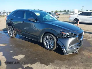2022 Mazda CX-30 S Premium with VIN 3MVDMBDL0NM413867, listed as a IAAI auction lot 42082560 with 12,375 mi miles and . Bid and sale history available at DreamBid. Image 1.