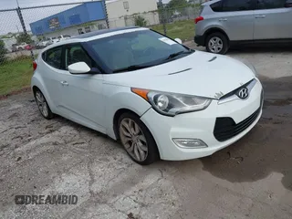 2013 Hyundai Veloster w/Black Int with VIN KMHTC6AD3DU164829, listed as a IAAI auction lot 41928028 with 123,995 mi miles and . Bid and sale history available at DreamBid. Image 1.