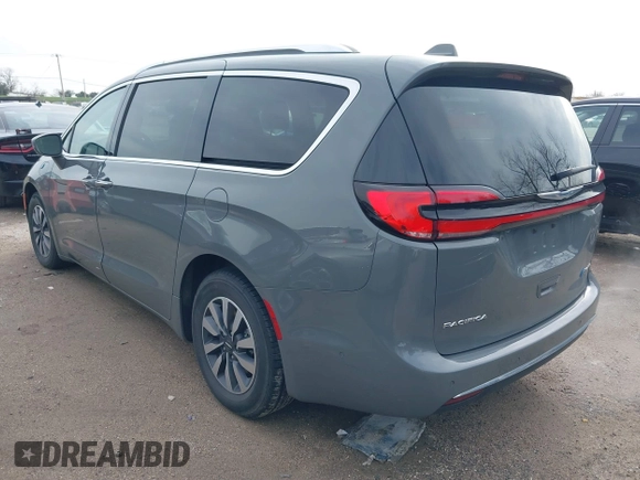 2021 Chrysler Pacifica Hybrid Touring L z VIN 2C4RC1L78MR596371, wystawiony jako IAAI lot #39993913 z przebiegiem 64 830 mil mil oraz . Historia ofert i sprzedaży dostępna na DreamBid. Obrazek 3.
