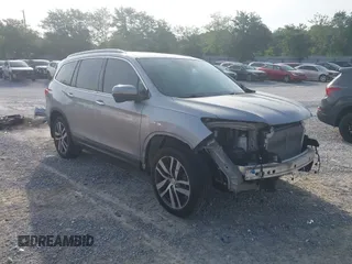 2017 Honda Pilot Touring z VIN 5FNYF6H9XHB041353, wystawiony jako IAAI lot #42289379 z przebiegiem 63 461 mil mil oraz . Historia ofert i sprzedaży dostępna na DreamBid. Obrazek 1.