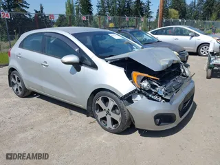 2014 Kia Rio SX with VIN KNADN5A31E6353714, listed as a IAAI auction lot 42127657 with 117,544 mi miles. Bid and sale history available at carsss.com. Image 1.