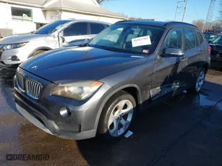 2014 BMW X1 sDrive28i with VIN WBAVM1C52EVW55890, listed as a IAAI auction lot 41512784 with 97,718 mi miles. Bid and sale history available at carsss.com. Image 2.