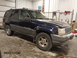 1997 Jeep Grand Cherokee Laredo with VIN 1J4GZ58S8VC675487, listed as a IAAI auction lot 41034046 with 243,284 mi miles. Bid and sale history available at carsss.com. Image 1.