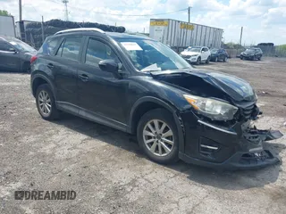 2016 Mazda CX-5 Sport z VIN JM3KE4BY2G0796577, wystawiony jako IAAI lot #42230645 z przebiegiem 103 223 mil mil oraz . Historia ofert i sprzedaży dostępna na DreamBid. Obrazek 1.