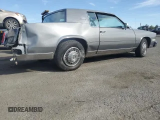 1985 Cadillac Eldorado z VIN 1G6EL5786FE628861, wystawiony jako Copart lot #76372384 z przebiegiem 15 146 mil mil oraz Szkody całkowita. Historia ofert i sprzedaży dostępna na DreamBid. Obrazek 3.