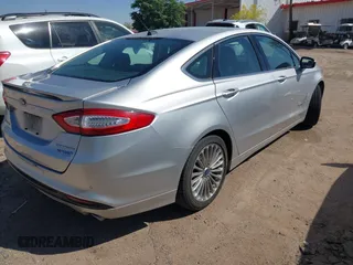 2014 Ford Fusion Titanium Hybrid with VIN 3FA6P0RUXER103516, listed as a IAAI auction lot 42004602 with 128,287 mi miles and . Bid and sale history available at carsss.com. Image 4.