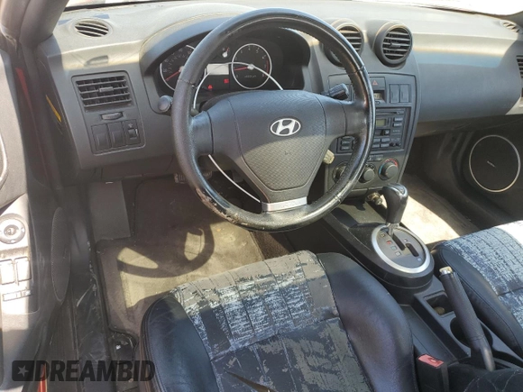 2003 Hyundai Tiburon GT z VIN KMHHN65F53U041351, wystawiony jako Copart lot #52332395 z przebiegiem 194 821 mil mil oraz Czysty tytuł • Clean title. Historia ofert i sprzedaży dostępna na DreamBid. Obrazek 8.
