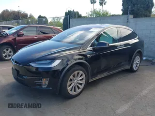 2020 Tesla Model X Long Range with VIN 5YJXCDE20LF265157, listed as a IAAI auction lot 41809572 with 58,599 mi miles. Bid and sale history available at carsss.com. Image 2.