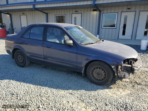 2000 Mazda Protege DX with VIN JM1BJ2222Y0303549, listed as a Copart auction lot 82674064 with 256,624 mi miles and Salvage Title. Bid and sale history available at carsss.com. Image 4.