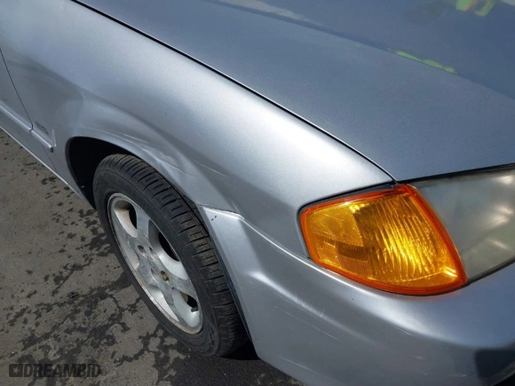 2000 Mazda Protege ES with VIN JM1BJ2218Y0283251, listed as a IAAI auction lot 41665289 with 141,336 mi miles. Bid and sale history available at carsss.com. Image 6.