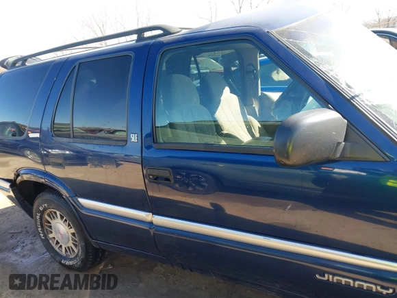 1999 GMC Jimmy SLE with VIN 1GKDT13W3X2553792, listed as a IAAI auction lot 41876489 with 266,884 mi miles. Bid and sale history available at carsss.com. Image 14.