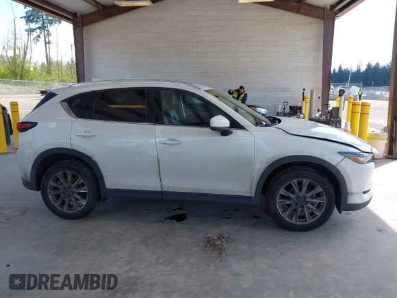 2020 Mazda CX-5 Grand Touring with VIN JM3KFBDM2L0863944, listed as a IAAI auction lot 42150805 with 63,932 mi miles and . Bid and sale history available at DreamBid. Image 13.