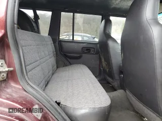 2000 Jeep Cherokee z VIN 1J4FF48S0YL254270, wystawiony jako Copart lot #52589415 z przebiegiem 166 860 mil mil oraz Szkoda całkowita • Salvage title. Historia ofert i sprzedaży dostępna na DreamBid. Obrazek 11.