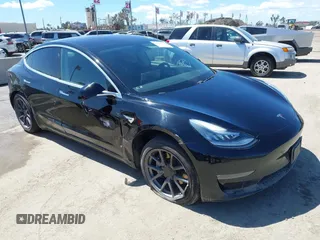 2019 Tesla Model 3 Mid Range with VIN 5YJ3E1EA3KF325056, listed as a IAAI auction lot 41771543 with 183,157 mi miles. Bid and sale history available at carsss.com. Image 1.