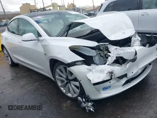 2020 Tesla Model 3 Standard Range Plus with VIN 5YJ3E1EA0LF741311, listed as a IAAI auction lot 41581931 with 43,284 mi miles. Bid and sale history available at carsss.com. Image 1.