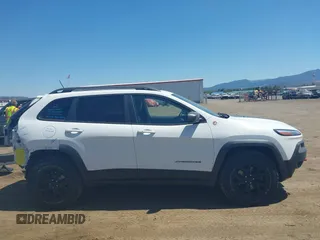 2014 Jeep Cherokee Trailhawk with VIN 1C4PJMBSXEW236807, listed as a IAAI auction lot 42660980 with 157,225 mi miles and . Bid and sale history available at DreamBid. Image 14.