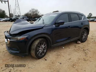 2019 Mazda CX-5 Grand Touring with VIN JM3KFADM0K1596256, listed as a Copart auction lot 86323594 with 118,853 mi miles and Salvage title. Bid and sale history available at DreamBid. Image 1.