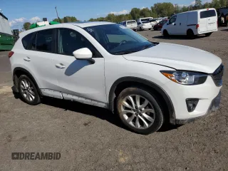 2014 Mazda CX-5 Grand Touring with VIN JM3KE4DY2E0354795, listed as a Copart auction lot 54205775 with 62,939 mi miles and Salvage Title. Bid and sale history available at DreamBid. Image 4.