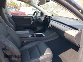 2023 Tesla Model Y Long Range with VIN 7SAYGDEE7PF856985, listed as a IAAI auction lot 42097675 with 13,112 mi miles and . Bid and sale history available at DreamBid. Image 5.